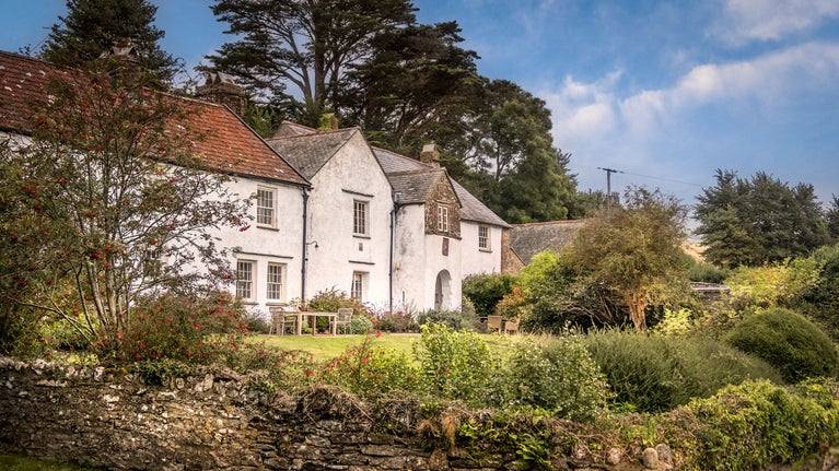 West Challacombe Manor and West Challacombe Cottage next door, with their shared garden in front, Devon